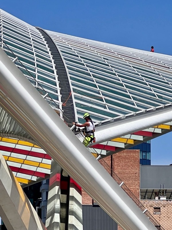 Maintenance technician performing scheduled upkeep on a rooftop facility structure