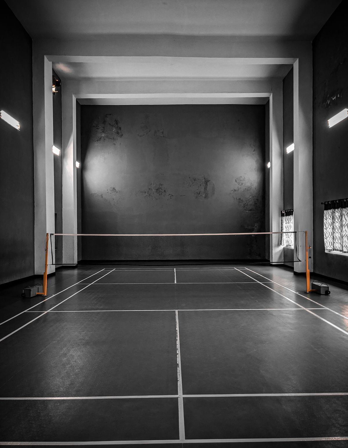 Empty indoor sports court showing court flooring and line markings