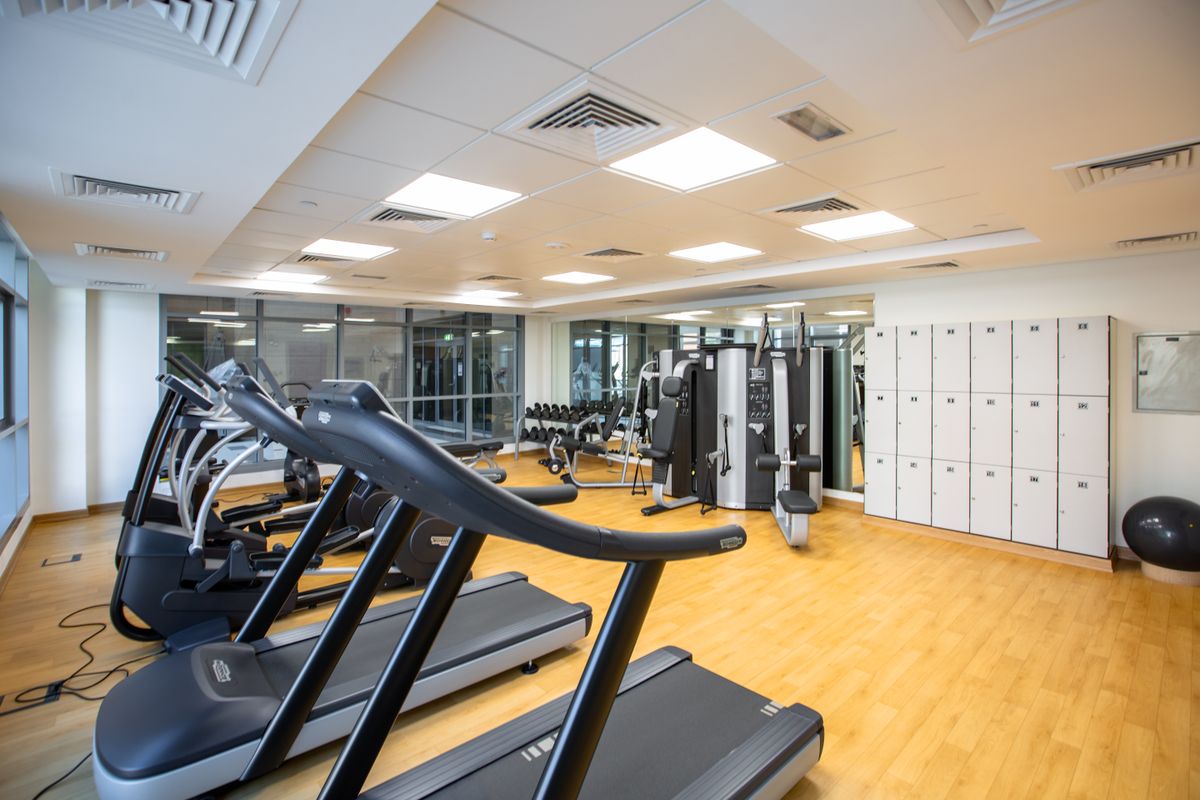 Spacious corporate gym interior with treadmills and fitness equipment