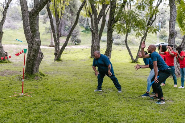 Group of colleagues taking part in an outdoor team activity during a company event