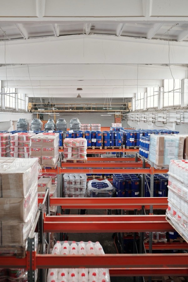 Warehouse shelving stacked with packaged supplies and shipping cartons