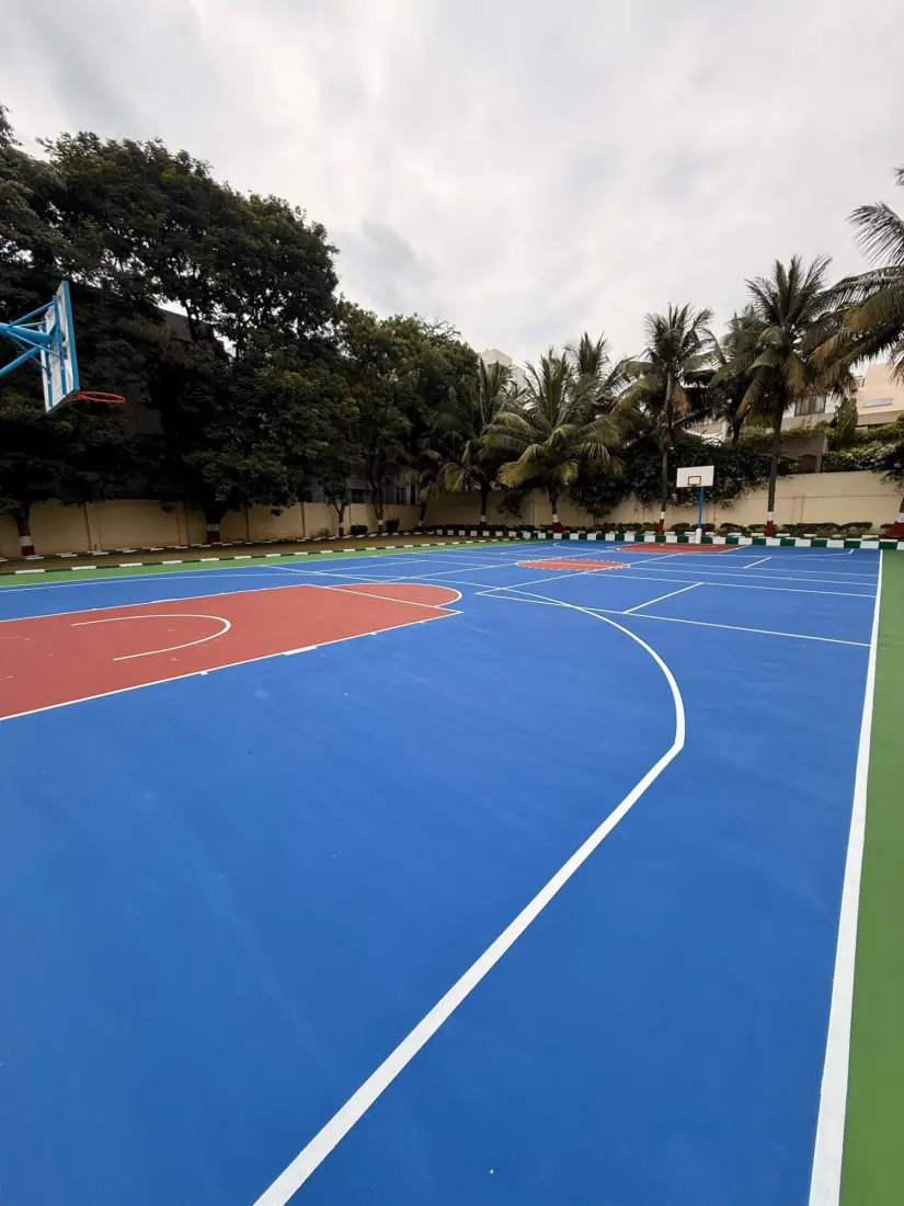 Anand Shiksha Kendra: a waterlogged, unused court resurfaced with an 8-layer acrylic system for basketball and pickleball